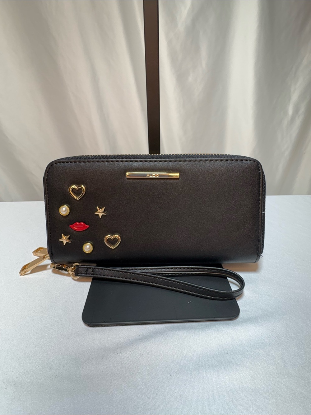 Aldo Black Zip-Around Wristlet Wallet with Gold Accents and Red Lip Detail
